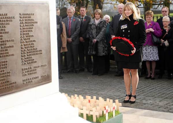 Brenda Hale MLA Laying a Wreath at Lisburn Cenotaph in memory of husband Captain Mark Hale who was killed in an explosion in Afghanistan in 2009, while fighting Taliban. US4611-129AO