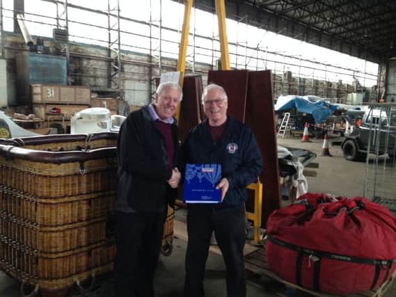 Ulster Aviation Society Chairman Ray Burrows takes delivery of a hot-air balloon from businessman Robin Mercer of Hillmount Garden Centre.