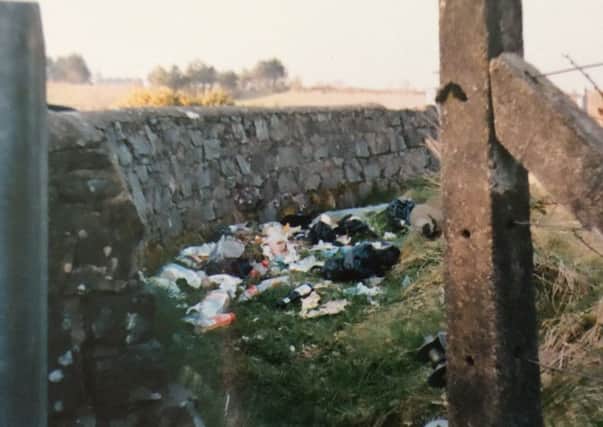 Rubbish dumped behind as wall at the reservoid at Cappagh. It's the same at the other entrance wall