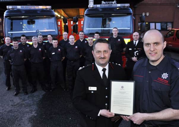 On behalf of Lisburn Retained, Watch Commander David Harbinson receives Chief Fire Officer's Commendation from Assistant Chief Fire Officer Gary Thompson for their role in saving the life of a citizen who almost drowned on New Years Day US1416-401PM Pic by Paul Murphy