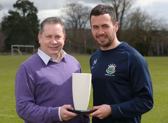 Stephen Looney presents the Northern Ireland Football Writers Association Player of the Month award to Linfield's Ross Gaynor