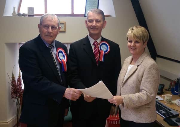Independent Unionist Maurice Devenney, centre, with his Election Agent, John Henry, and Deputy Returning Officer, Patricia Murphy at the Electoral office at Queen Street, Londonderry