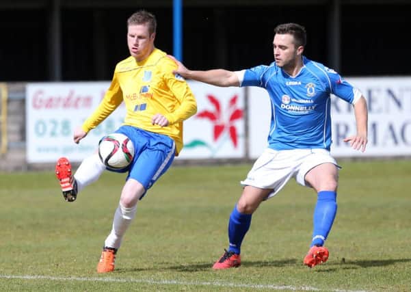Darren Henderson shields the ball from Dungannon defender Chris Hegarty during Saturday's match. Picture: Press Eye.
