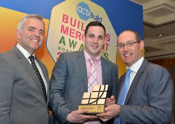 Pictured here are David Brown, Manager, Haldane Fisher, Coleraine, receiving the Overall Award from Minister Bell and Tadhg Donohoe, Chairman, Octabuild (right).