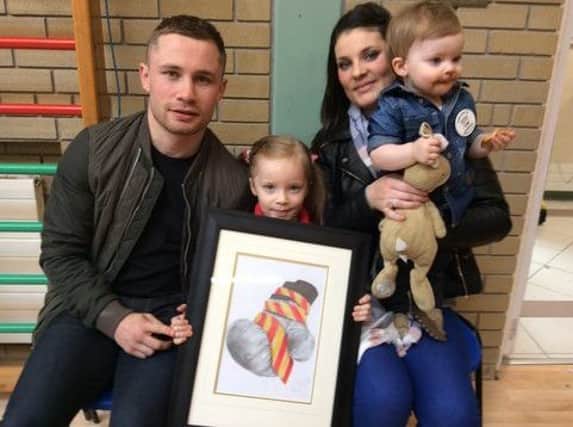 Carl Frampton. his wife Christine, his daughter Carla and son Rossa with  with a specially commissioned framed print given to him by Bridge Integrated Primary School in recognition of him becoming World Champion, during his recent visit to the school to launch Integrated Education Week.
