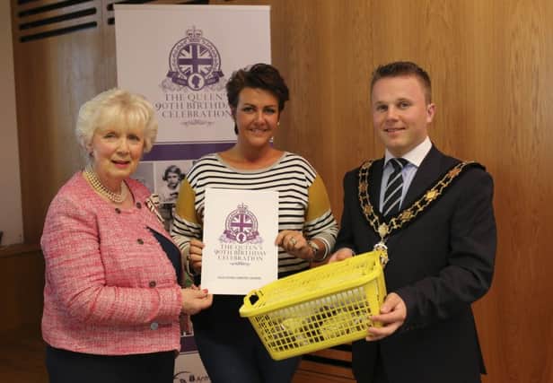 Michelle Wilson from South Antrim Community Network receiving their event pack from the Lord Lieutenant and the Mayor.