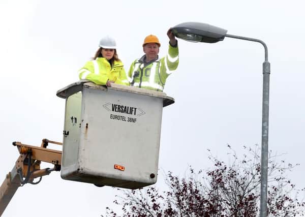 Regional Development Minister, Michelle McIlveen with TransportNI Street Lighting operative Michael Maguire as she announced extra funding to tackle the backlog of broken street lights. Presseye