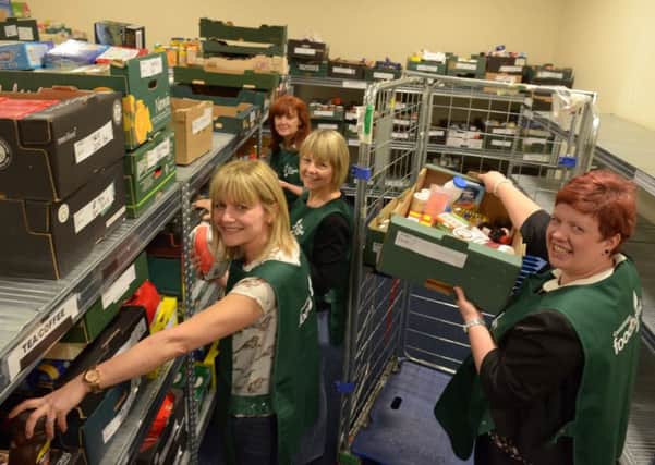 Stacking the shelves at the Trussell Trust Carrickfergus Foodbank. INCT 16-340-PR