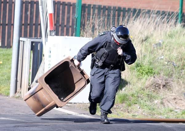 Press Eye - Belfast - Northern Ireland - 28th March 2016

Trouble starts in the Lake Street area of Lurgan as nationalist youths throw stones at police and set a wheelie bun on fire on the railway line.  A PSNI officer removes the bin from the tracks. 

Picture by Jonathan Porter/PressEye