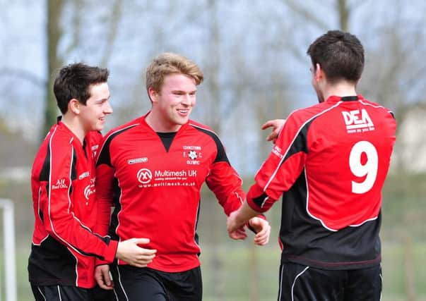 Cookstown Olympic's Niall Doyle celebrates with team mates after scoring his side's first goal during Saturday's league encounter with Mallusk Athletic at Beechway.INMM1116-343