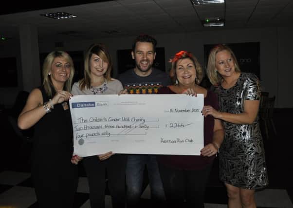 Kernan Run Club's Christmas party in Chambers Park provided the perfect opportunity for a cheque presentation of Â£2364 to the Northern Ireland Childrens Cancer Unit. From left to right are Caroline Walker, Debbie McCann (NI Children's Cancer Unit), Gareth Irvine, Jennifer Cahoot (NI Children's Cancer Unit) and Ceira Eakin.