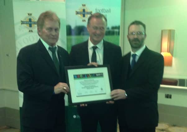 Michael O'Neill presents Northend United's Johnny Sayers and Brian McCluney with the Club Excellence Mark 2-Star certificate.