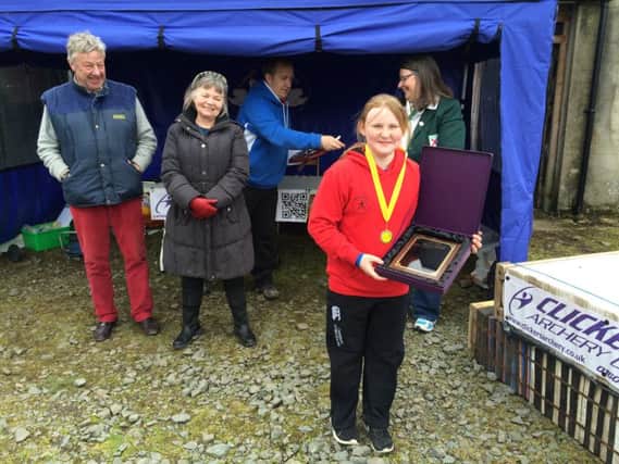 Young Sinead Byrne receiving her NIAS Championship plaque from Lord and Lady Dunleath in the class for girls under 12 compound barebow.