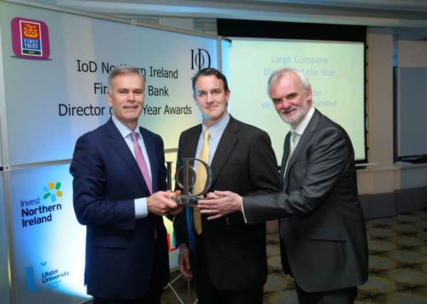 Des Moore, of First Trust Bank, and Awards Host Tim McGarry, present David Barnett who accepted the  Large Company Director of the Year award on behalf of Mark Nodder, sponsored by First Trust Bank, at the 2016 IoD NI First Trust Bank Director of the Year Awards ceremony, which took place at the Merchant Hotel on Friday. Image submitted