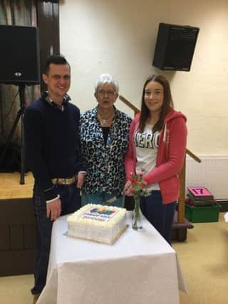 Committee Members David Millar, Elizabeth Craig (Chairperson) and Chloe McGall cutting the birthday cake