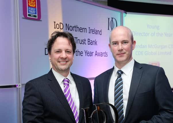 Richard Ennis of sponsors First Trust Bank presents Raymond Cooke of CDE Global Ltd, with the Young Director of the Year award, sponsored by First Trust Bank, at the 2016 IoD NI First Trust Bank Director of the Year Awards ceremony, which took place at the Merchant Hotel on Friday.
