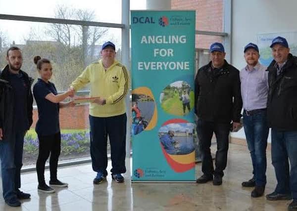 Representatives from DCAL (left) pictured presenting David Rush, Vice-chair New Mossley Community Group with fishing permits. Also pictured are Andy Twigg, Cllr Stephen Ross and Jack Shaw, New Mossley Community Group Chair. INNT 16-804CON
