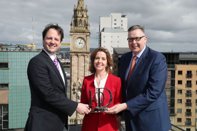 Richard Ennis of sponsors First Trust Bank and Paul Terrington, chairman of the IoD NI, present Carla Tully, president of AES UK & Ireland, with the Director of the Year for Leadership in Corporate Responsibility Award. INCT 16-785-CON
