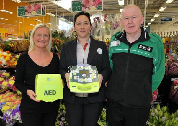 St John Ambulance's John Beattie and Tesco Northcott staff Shelley Bryans and Kim O'Donnell with the store's new defibrillator. INNT 16-200-AM