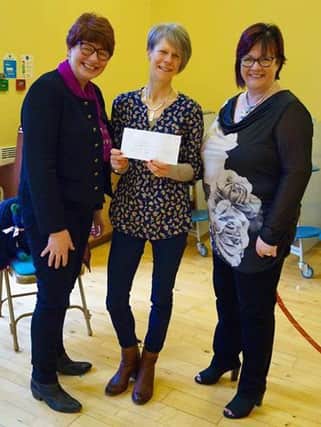 Bushvalley School staff present cheque to Debbie McAfee. INBM18-16S