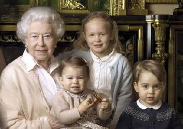 Queen Elizabeth II poses with her two youngest grandchildren, James, Viscount Severn and Lady Louise (the son and daughter of the Earl and Countess of Wessex), along with her five great-grandchildren Mia Tindall (front, holding handbag), Savannah Philipps, Isla Phillips, Prince George and Princess Charlotte in the Green Drawing room at Windsor Castle in Windsor.  Photo: Annie Leibovitz