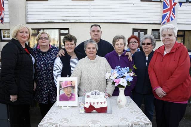 Maisie Crawford, centre, pictured with some of the residents who gathered at Ã¢Â¬ÃœMaisieÃ¢Â¬"s SquareÃ¢Â¬", Caw, on Wednesday evening to celebrate the QueenÃ¢Â¬"s 90th birthday. INLS1716-104KM