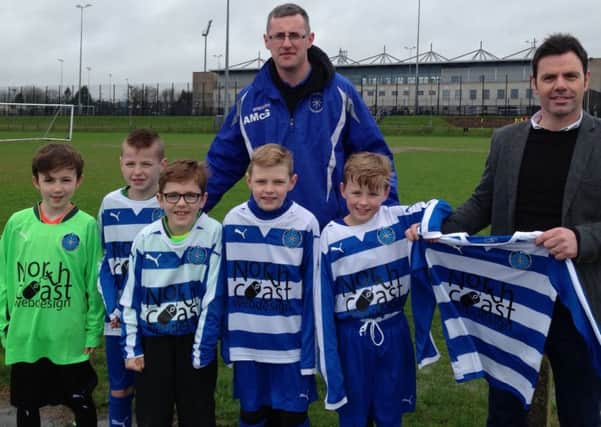 Darren McGinley, of North Coast Web Design, hands over a new sponsored kit to Conal McAuley and Northend Youth players. Also included is Northend U10 Manager Ally McGarry.