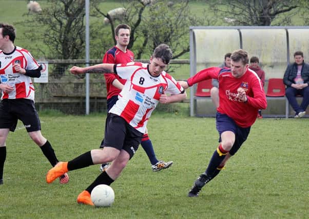 Clough Rangers Athletic attempt to close down a Ballyclare Northend player's forward burst. INBT 18-834H