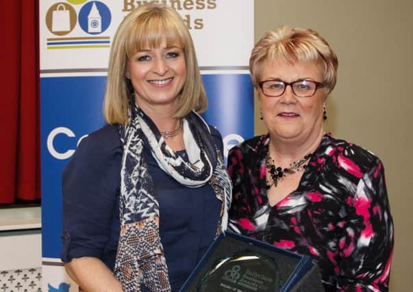 Lorraine McConnell (left), owner of Joli, accepts the Retailer of the Year award from Cllr Vera McWilliam.