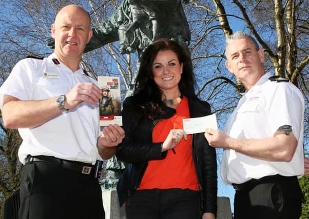 Victoria Barkley presents the cheque for the Firefighters Charity to Assistant Chief Fire Officer Alan Walmsley (left) and Southern Area Commander Lloyd Crawford. INNT 17-516CON
