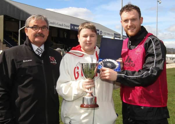 On Saturday Lisburn Distillery defender Ciaran Burns (right) was presented with the Grosvenor Whites Supporter's Club Player of the Year Award by Bobby Radcliffe (left) and Thomas Sharkey. Picture - David Hunter.