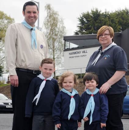 Morris Gilmore and Cathie Garrett pictured with some 6th Lisburn Squirrels - Evan, Ethan and Brodie.