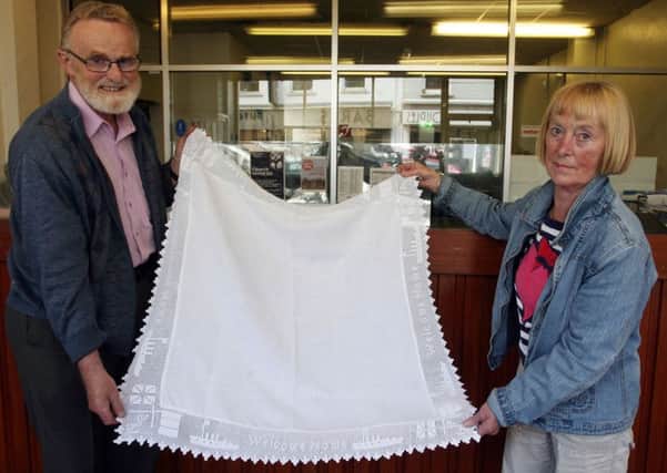 Tom Montgomery and Doreen Mairs with the table cloth with the WWI naval memorial. INBT34-203AC