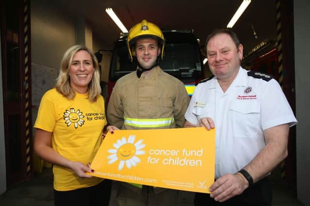 Banbridge Fire Fighter Richie Johnston will be running this years Belfast Marathon in full fire fighters kit for The Cancer Fund For Children represented by Amanda Steele, events fund raiser and the Fire Fighters Benevolent Fund for Victor Spence, District Commander.  C1611112.