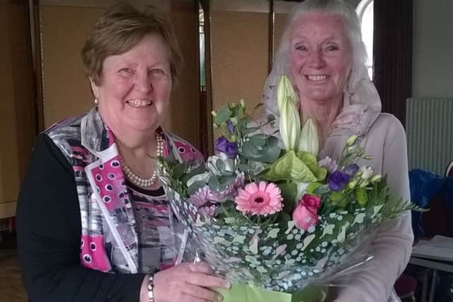 Incoming chairperson Norma Galway, right, hands over a bouquet to outgoing chairperson Frances McKeown. INPT18-001