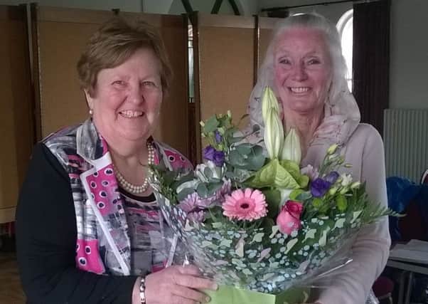 Incoming chairperson Norma Galway, right, hands over a bouquet to outgoing chairperson Frances McKeown. INPT18-001