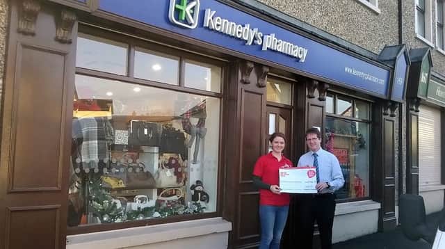 Sinead Magill, representative of Northern Ireland Chest Heart and Stroke receiving a cheque from Patrick Kennedy on behalf of the staff and customers of Kennedys Pharmacy, Rasharkin and Dunloy