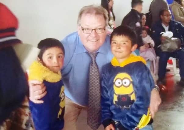 Pastor Drew Hamill with two young children from the Juan Rey region.  INCT 18-726-CON