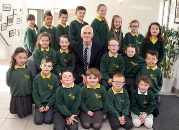 BYE BYE. Principal,  Malachy Conlon, who is leaving his post as Principal of St Brigid's PS, pictured with the school's Council members  and Pupils of the Month on Thursday.INBM18-16 015SC.