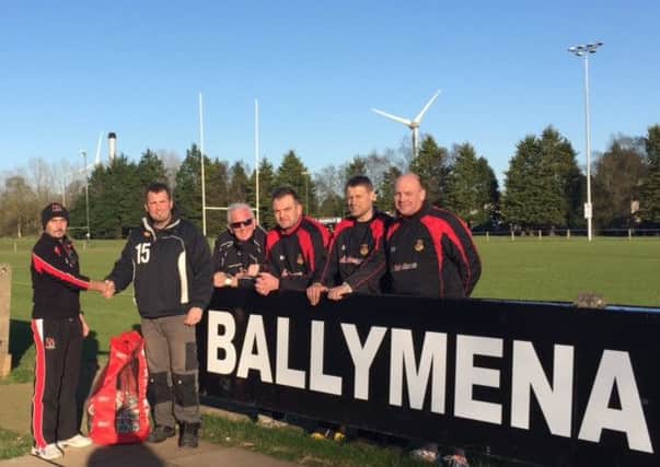 Ulster Rugby's Regional Rugby Lead Ricky Huey presents Ballymena Rugby Club Youth Convenor Don Pattison with the Ulster Carpets Club of the Month prize. Included are some of the club coaches, from L-R T. Wiggins, C. Craig, S. Bracewell & A. Walker.