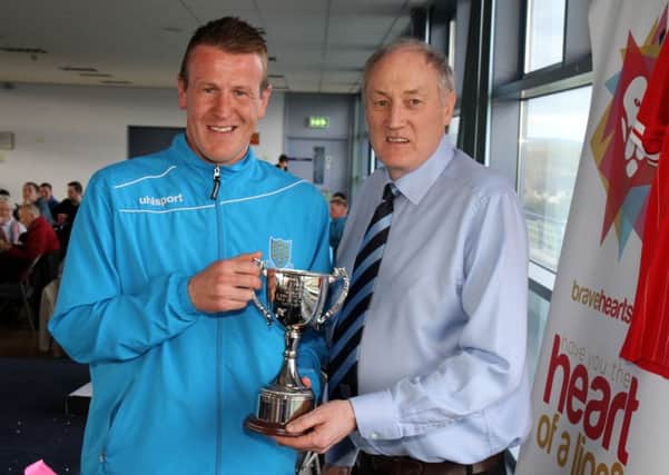 United chairman John Taggart presents Allan Jenkins with the Noel Millar Memorial Trophy.