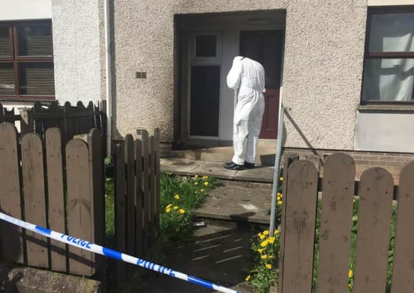 Police at the scene of a petrol bomb attack on a Coagh home. The 22-year-old man who was inside at the time was unhurt. May 2