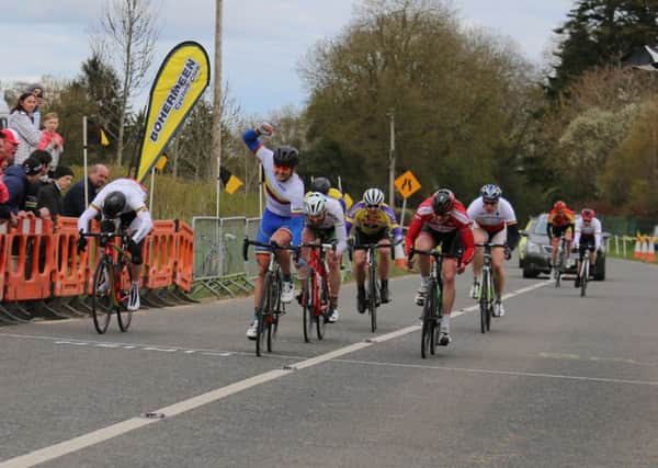 Nathan Mullan punches the air as he crosses the line victorious after 115km of hard racing around County Meath.