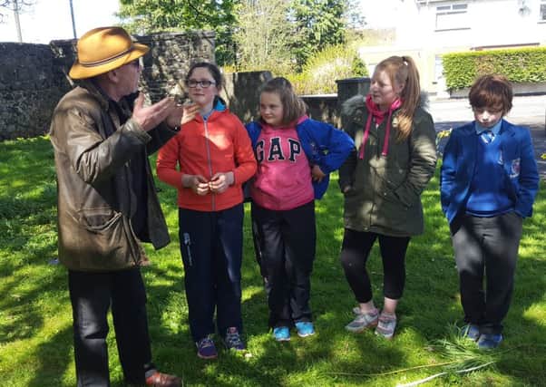 Pupils from Macosquin Primary School with  archaeologist Nick Brannon at a dig in the village last week. INCR19 NF