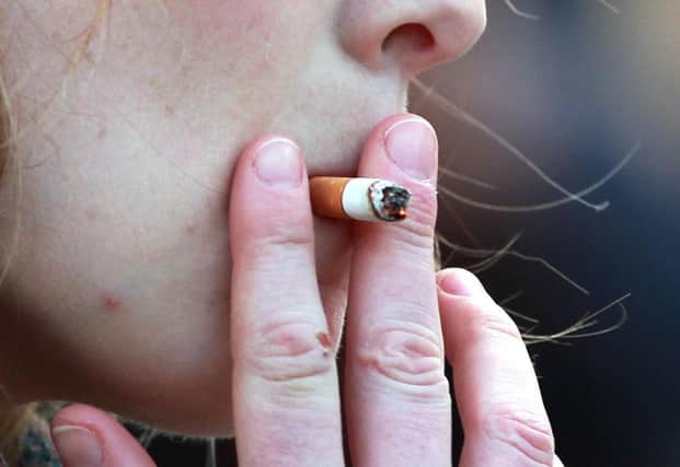 File photo dated 21/02/14 of a person smoking, as bans across the UK could have reduced the number of teenage girls who take up smoking, new research suggests. PRESS ASSOCIATION Photo. Issue date: Thursday February 25, 2016. A new study has found that the ban on smoking indoors has had an impact on the number of 15-year-old girls taking up the habit. See PA story HEALTH Smoking. Photo credit should read: Sean Dempsey/PA Wire