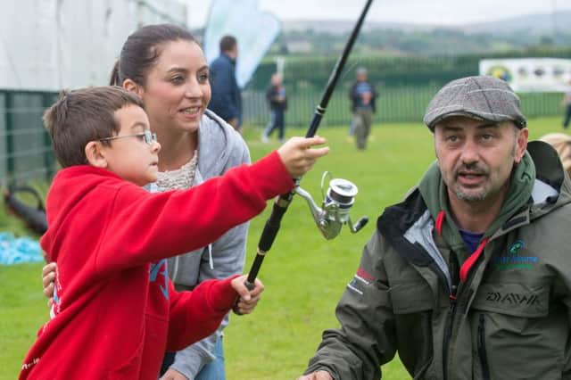 No Fee for reproductionJamie McGuigan and Lisa french from Sion Mills are pictured with casting coach Anthony Connolly, enjoyingÂ Fish Fest 2014 which took place at Vaughans Holm, Newtownstewart at the weekend, and wasÂ organised by Strabane District Council, supported by Loughs Agency and funded through Axis 3 of the Northern Ireland Rural Development Programme. Picture Martin McKeown. Inpresspics.com.