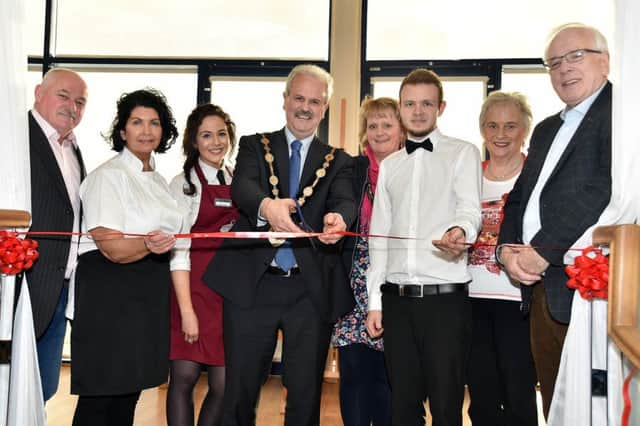 The Mayor of Lisburn and Castlereagh Council, Councillor Thomas Beckett, centre, cuts the ribbon to officially open the VIP Vintage Tea Area at Cafe Vic Ryn. Also included are from left, Hugh Evans, Jacqueline Evans, owner, Grace  Killen, counter assistant, Linda Beckett, Mayoress, Glen Scales, supervisor, Denise Ewart and Alderman Allan Ewart.
Photo by Tony Hendron / Press Eye