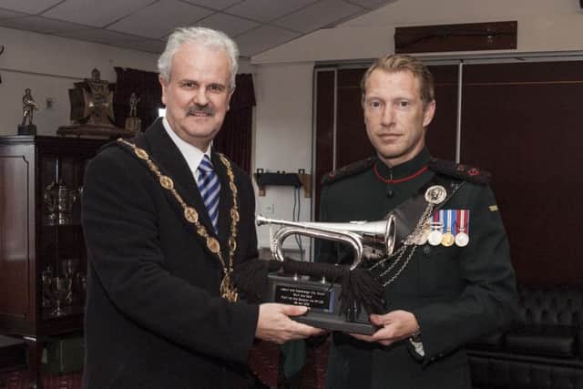 The Mayor of Lisburn & Castlereagh City Council, Councillor Thomas Beckett accepts a Silver Bugle from Lt Col Neil Bellamy (Commanding Officer 2 Rifles) at the recent Sounding Retreat at Thiepval Barracks, Lisburn.