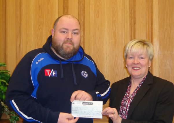 Michael Clarke - Clan na Gael and Bernadette McGeown Operations Manager LCU making a presentation for Clan na Gael. This renewed sponsorship will assist in the purchase of playing gear and transport for the under-18 teams and lower, in order for them to play in matches in different locations and use new, high-quality equipment.