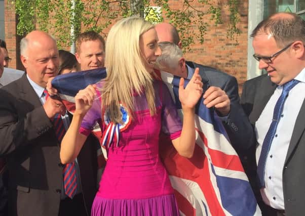 Carla Lockhart  is wrapped in a Union flag outside Banbridge Leisure Centre after being elected in Upper Bann